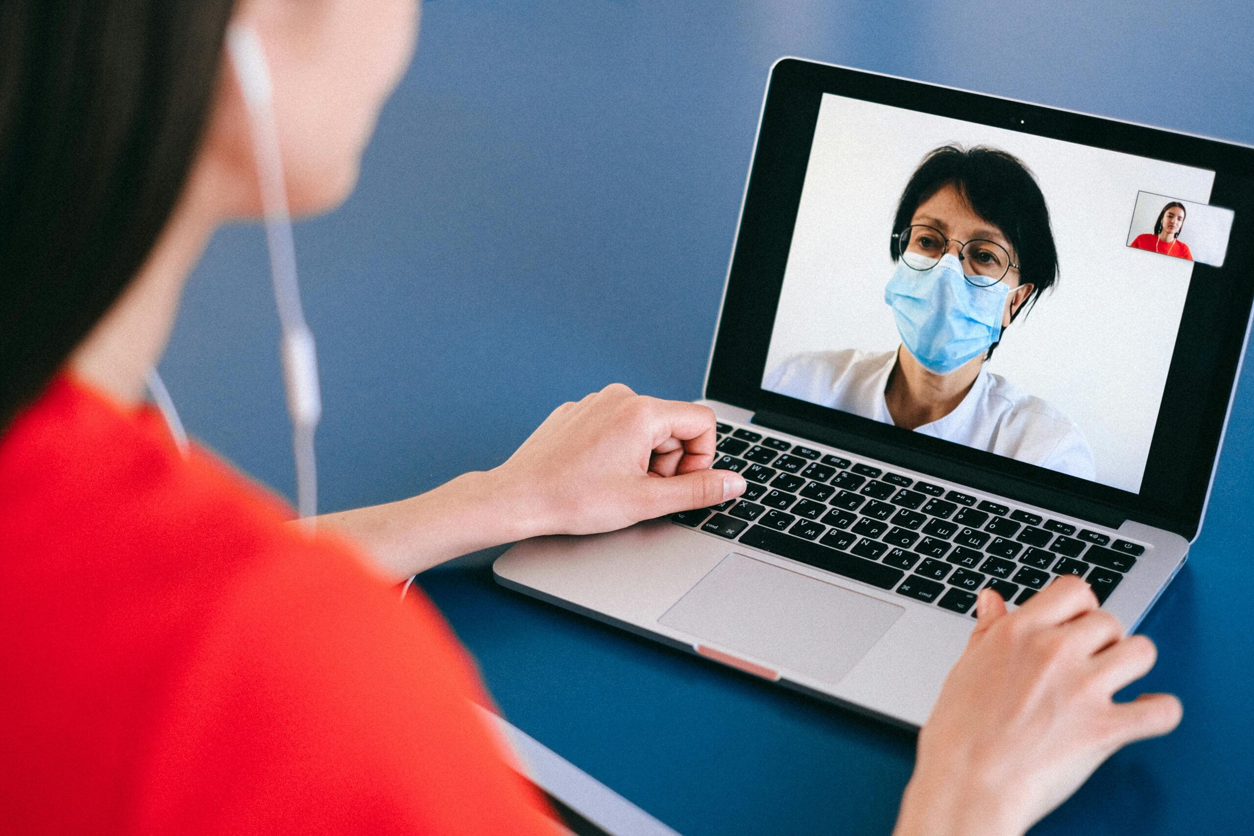 Doctor and patient on a video call for telehealth consultation during COVID-19 era.